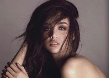Kim Domingo topless on racy magazine cover .